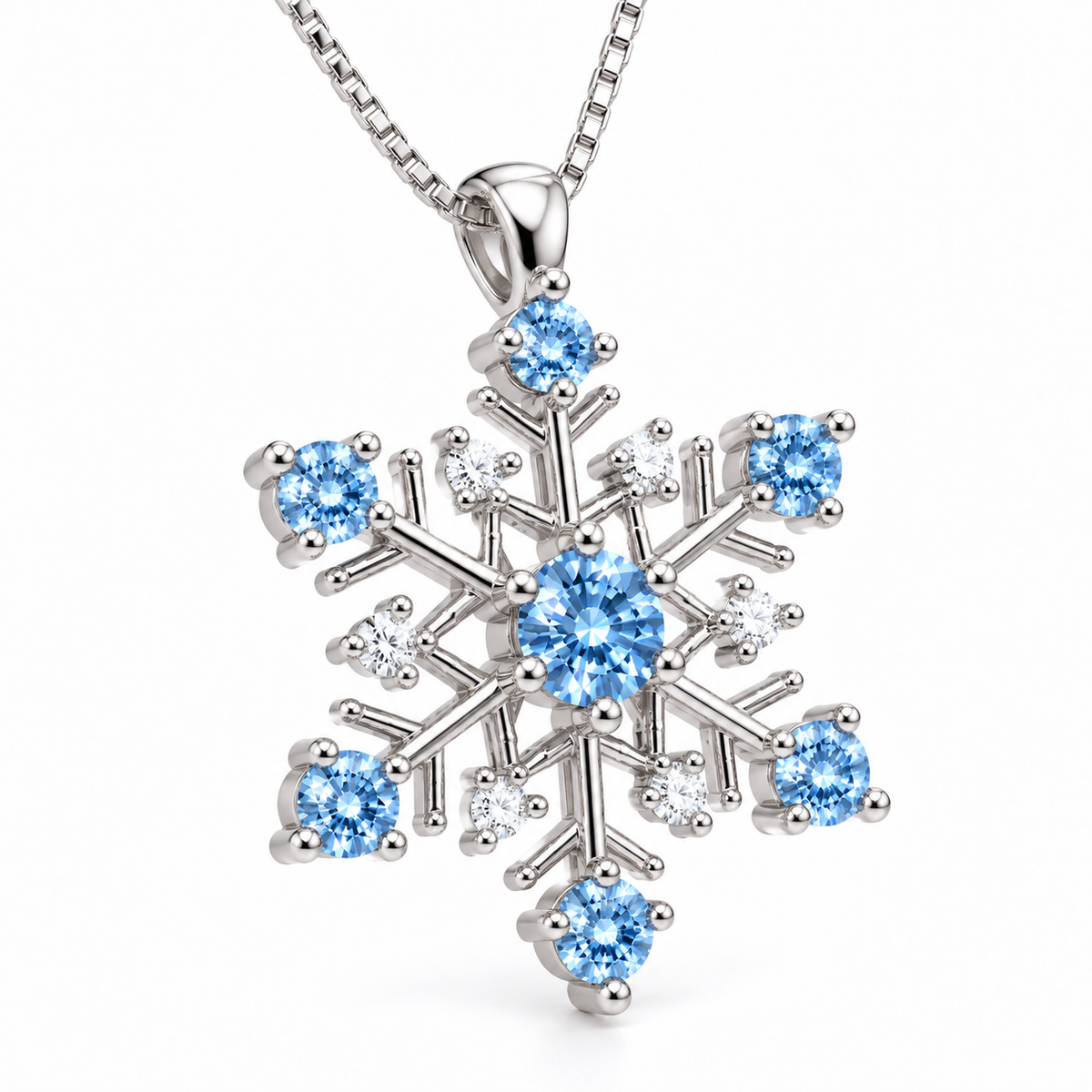 Angled view of an icy blue moissanite snowflake pendant necklace showcasing the six-point sterling silver snowflake design, brilliant blue moissanite gemstones, clear white cubic zirconia accents and polished silver prong settings against a white background.