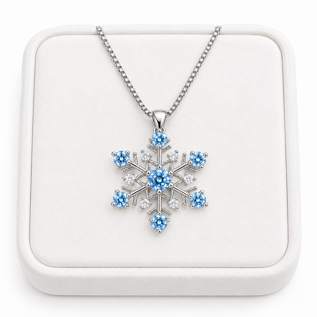 Phimsera icy blue moissanite snowflake necklace displayed on a premium white velvet jewelry tray against a pure white background, featuring a sparkling blue center gemstone, six icy blue moissanite tips, clear cubic zirconia accents and delicate sterling silver chain.