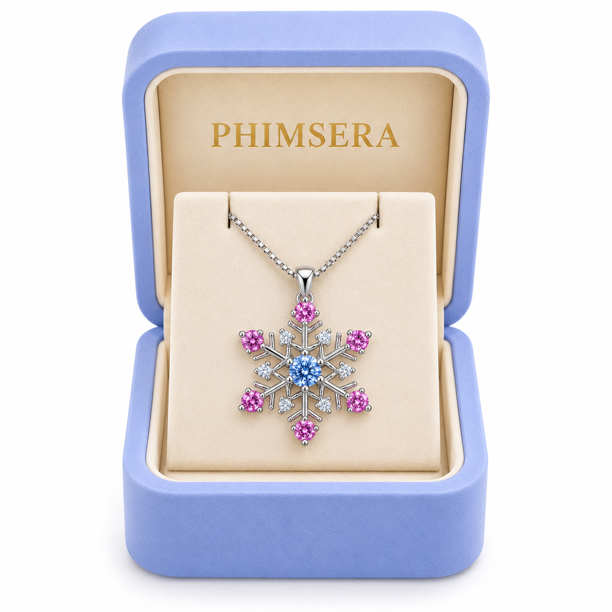 Icy blue and pink moissanite snowflake necklace displayed inside a periwinkle Phimsera jewelry gift box with ivory velvet interior and gold PHIMSERA lettering, featuring a delicate silver chain and colorful snowflake pendant.