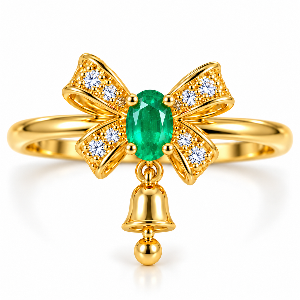 Front view of Phimsera natural emerald Christmas bow ring featuring a 3x4mm oval vivid green emerald, sparkling white CZ ribbon bow and dangling gold bell charm in gold-plated 925 sterling silver.