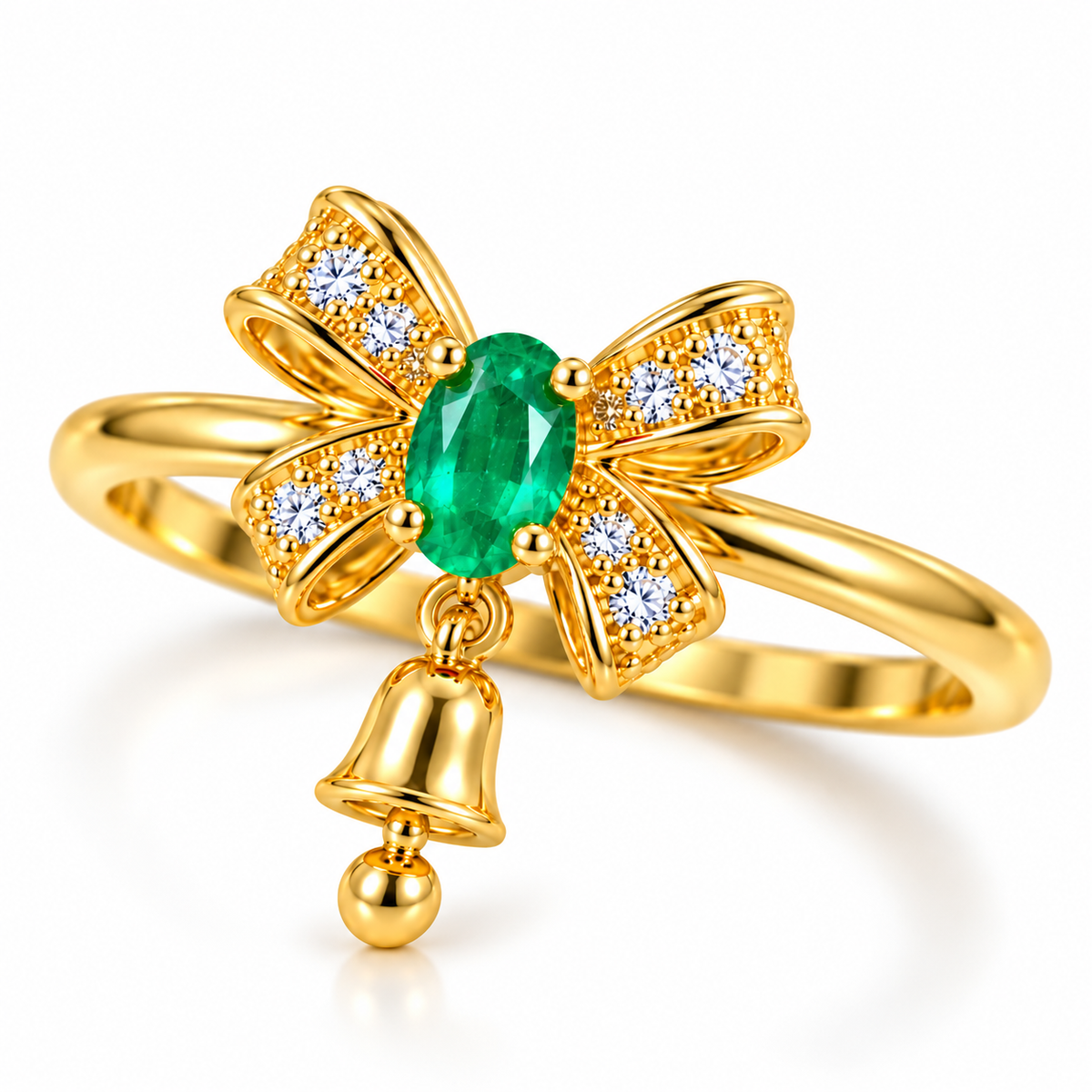 Three-quarter angled view of gold-plated sterling silver emerald bow ring showing its oval natural emerald, four sparkling CZ ribbon sections, slender polished band and petite dangling Christmas bell.