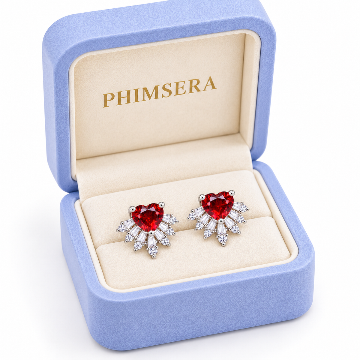 Angled view of a periwinkle Phimsera jewelry gift box containing natural 6mm red garnet heart earrings with brilliant cubic zirconia sunburst accents, ivory jewelry insert, and gold Phimsera branding.
