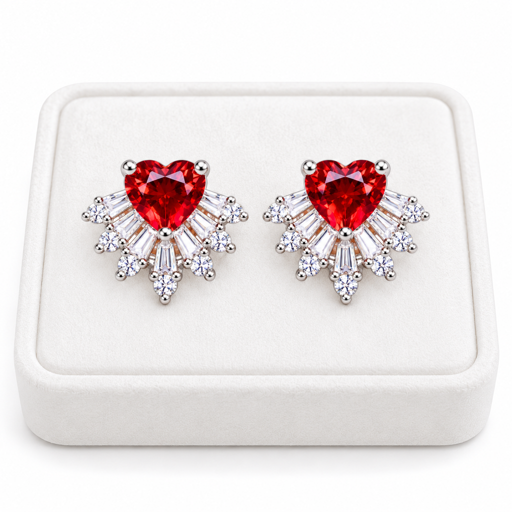 Pair of natural red garnet heart stud earrings with 6mm gemstones and sparkling cubic zirconia sunburst accents displayed on a premium white velvet jewelry tray against a pure white background.