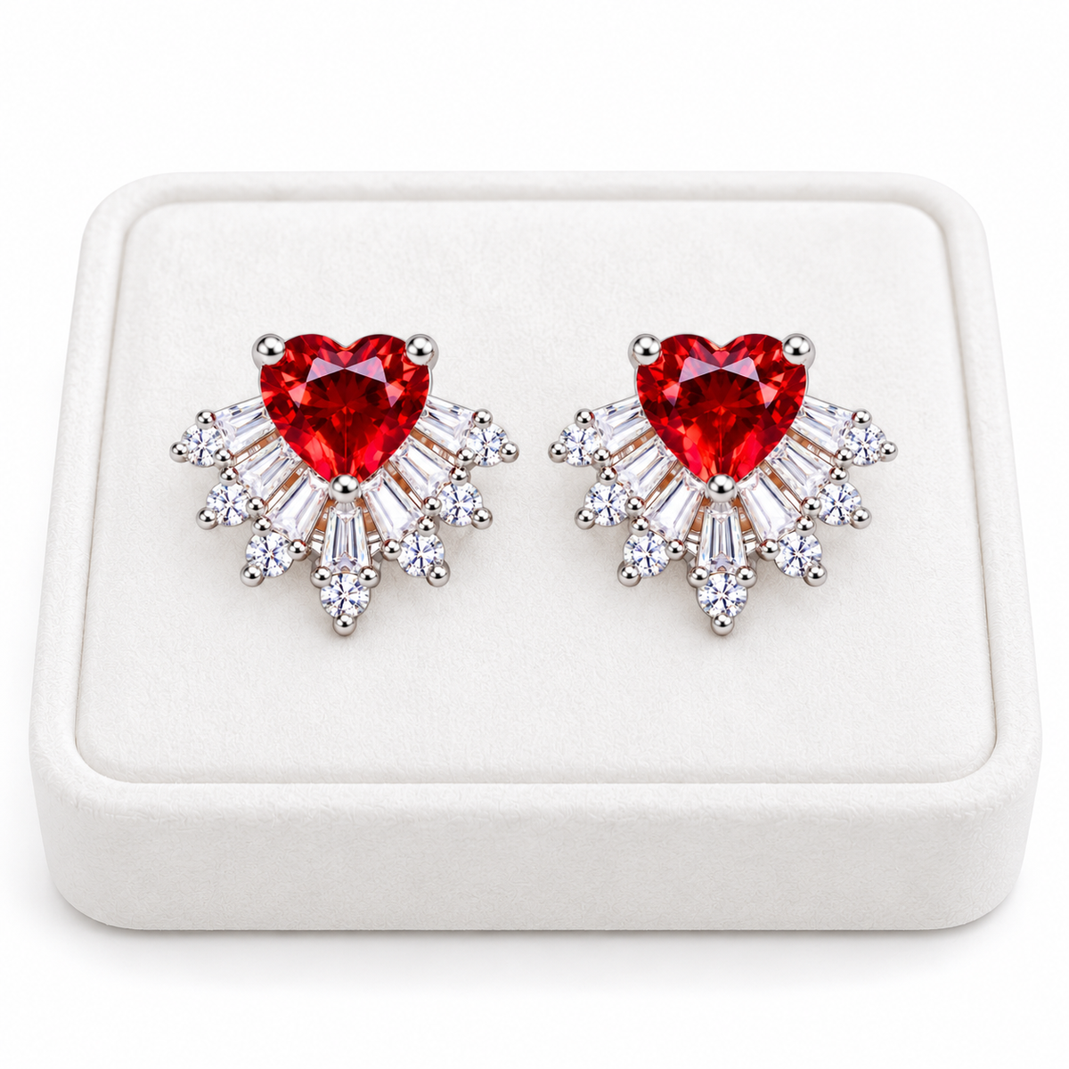 Pair of natural red garnet heart stud earrings with 6mm gemstones and sparkling cubic zirconia sunburst accents displayed on a premium white velvet jewelry tray against a pure white background.