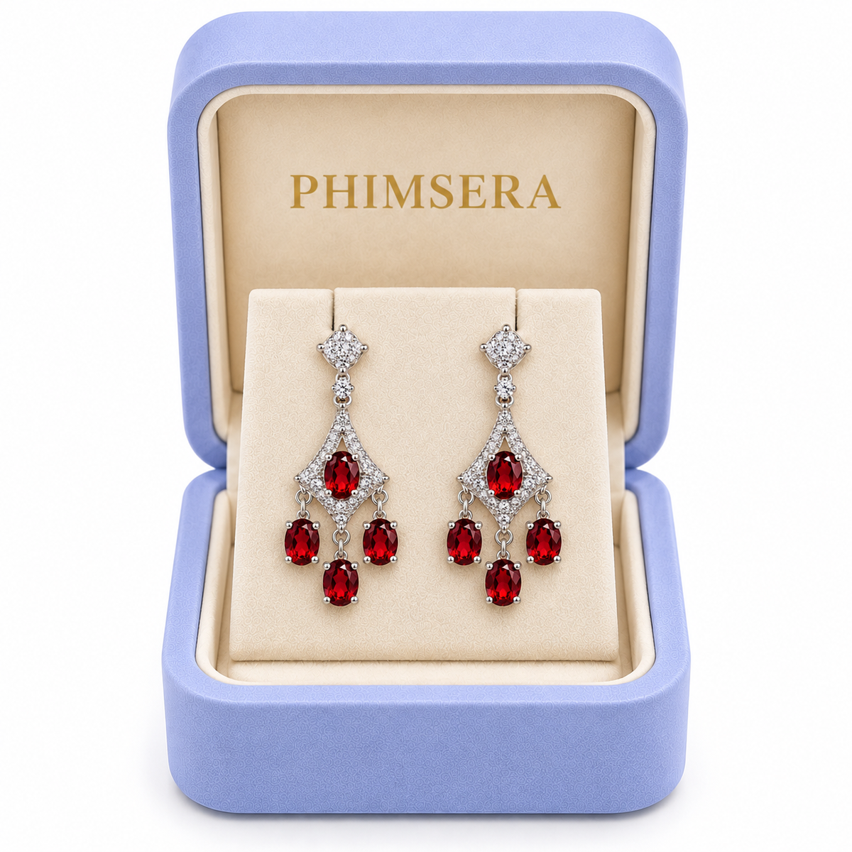 Natural red garnet chandelier dangle earrings displayed inside an open periwinkle Phimsera jewelry gift box with an ivory interior and gold Phimsera logo, featuring sparkling cubic zirconia accents and cascading 4x5mm crimson-red garnet gemstones against a pure white background.