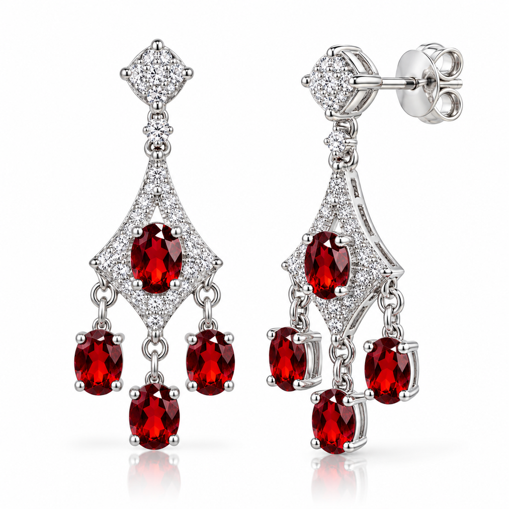 Angled view of natural red garnet chandelier earrings with 4x5mm oval gemstones, sparkling cubic zirconia accents, polished sterling silver openwork settings, three dangling garnet drops per earring, and butterfly-back closures.