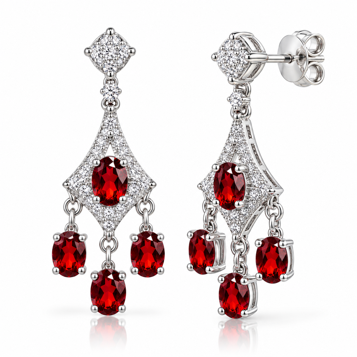 Angled view of natural red garnet chandelier earrings with 4x5mm oval gemstones, sparkling cubic zirconia accents, polished sterling silver openwork settings, three dangling garnet drops per earring, and butterfly-back closures.
