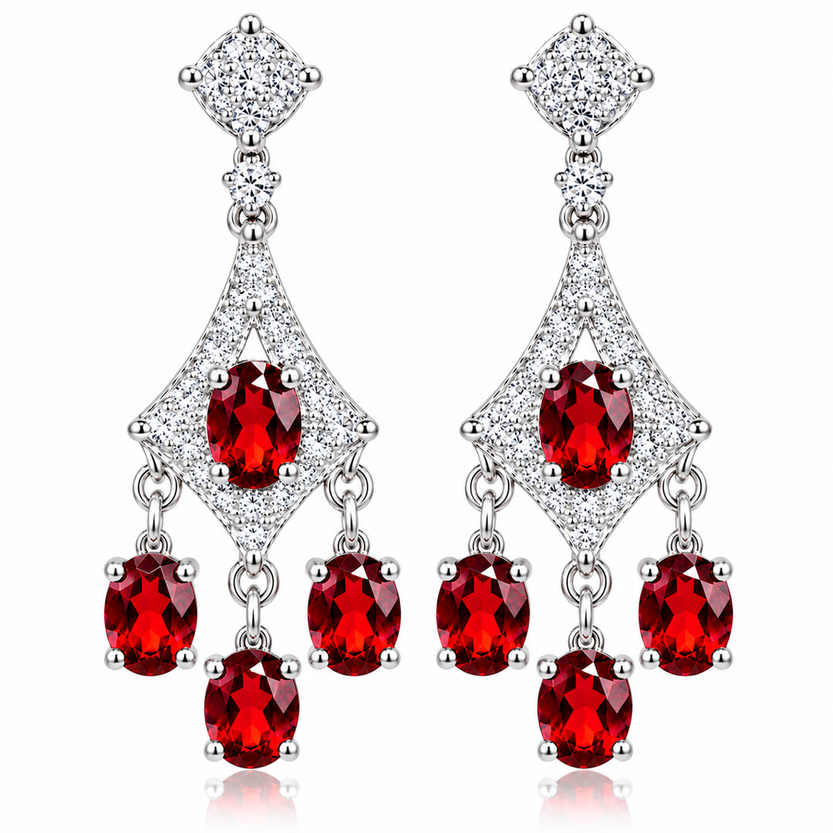 Front-facing photograph of matching natural red garnet chandelier dangle earrings featuring oval 4x5mm crimson gemstones, sparkling cubic zirconia geometric frames, and three cascading garnet drops beneath each earring on a pure white background.