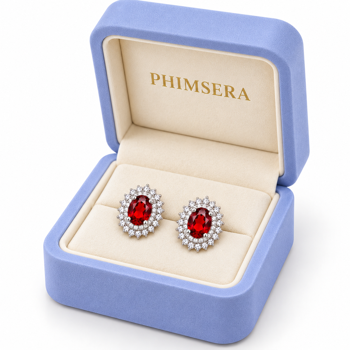 Angled view of a periwinkle Phimsera jewelry gift box containing natural 5x7mm red garnet double halo stud earrings with sparkling cubic zirconia sunburst settings, polished sterling silver prongs, and a soft ivory jewelry insert.