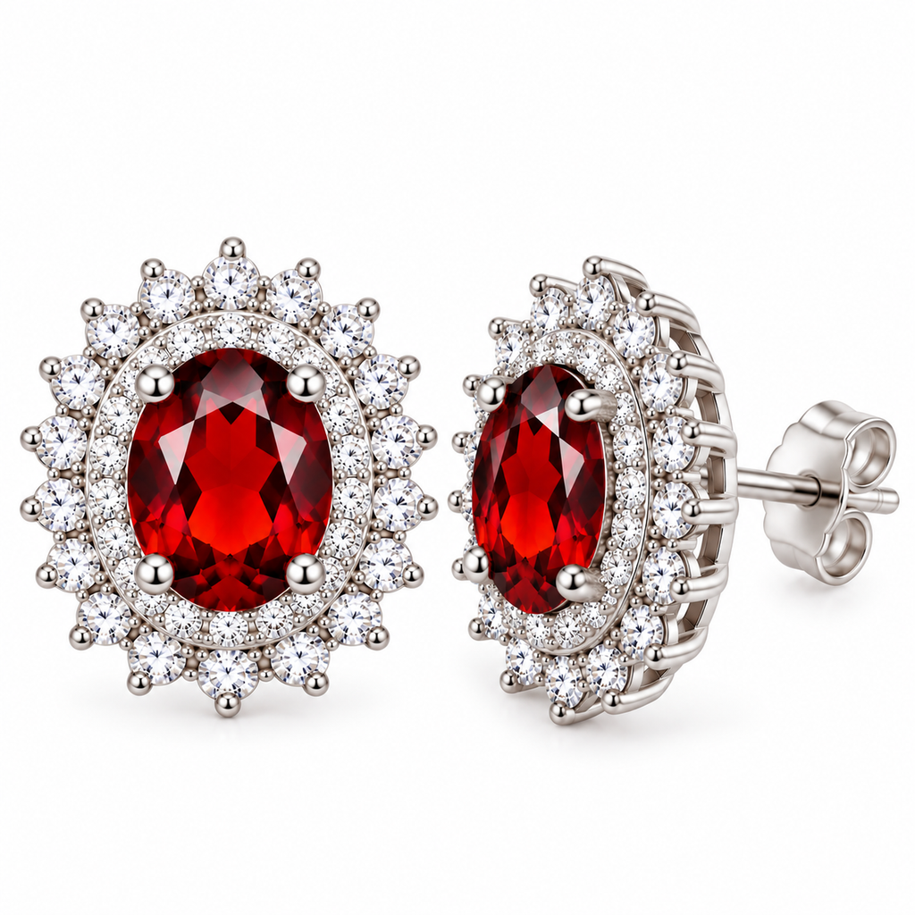 Natural red garnet double halo stud earrings showing one 5x7mm oval crimson gemstone from the front and the other at an angle, highlighting sparkling cubic zirconia halos, polished sterling silver settings, and earring post construction.