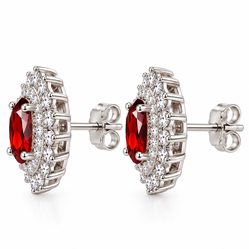 Side profile of natural red garnet double halo stud earrings featuring 5x7mm oval gemstones, layered cubic zirconia sunburst halos, polished sterling silver open-gallery settings, centrally positioned posts, and butterfly backs.