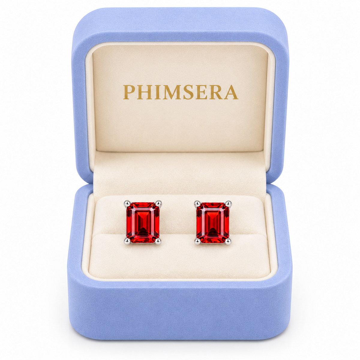 Natural 6x8mm red garnet emerald cut stud earrings displayed inside an open periwinkle Phimsera jewelry gift box with an ivory interior, gold Phimsera logo, and pure white background.