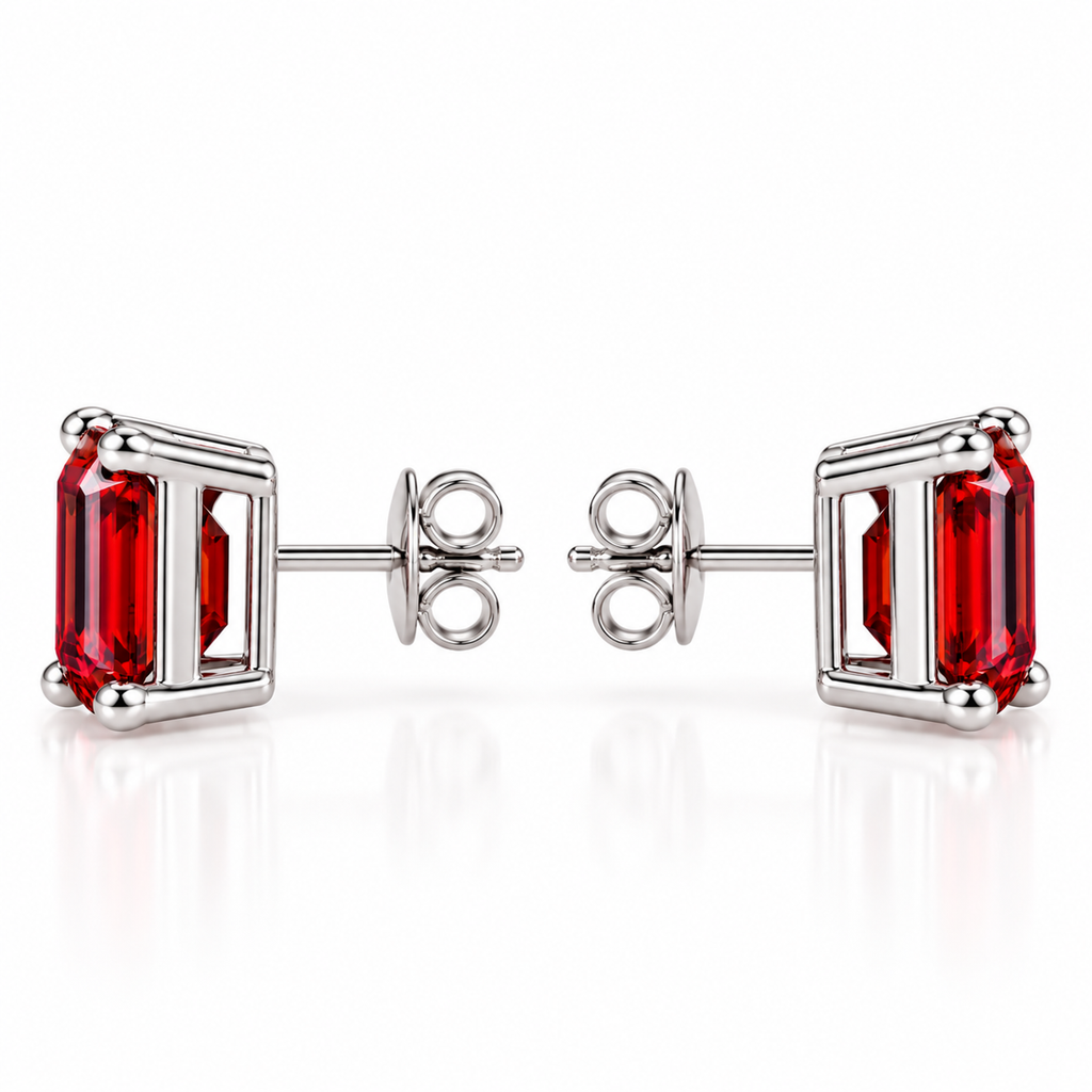 Side profile of natural 6x8mm red garnet emerald cut stud earrings showing rectangular gemstone depth, polished sterling silver open-gallery settings, four rounded corner prongs, centrally positioned posts, and butterfly backs.