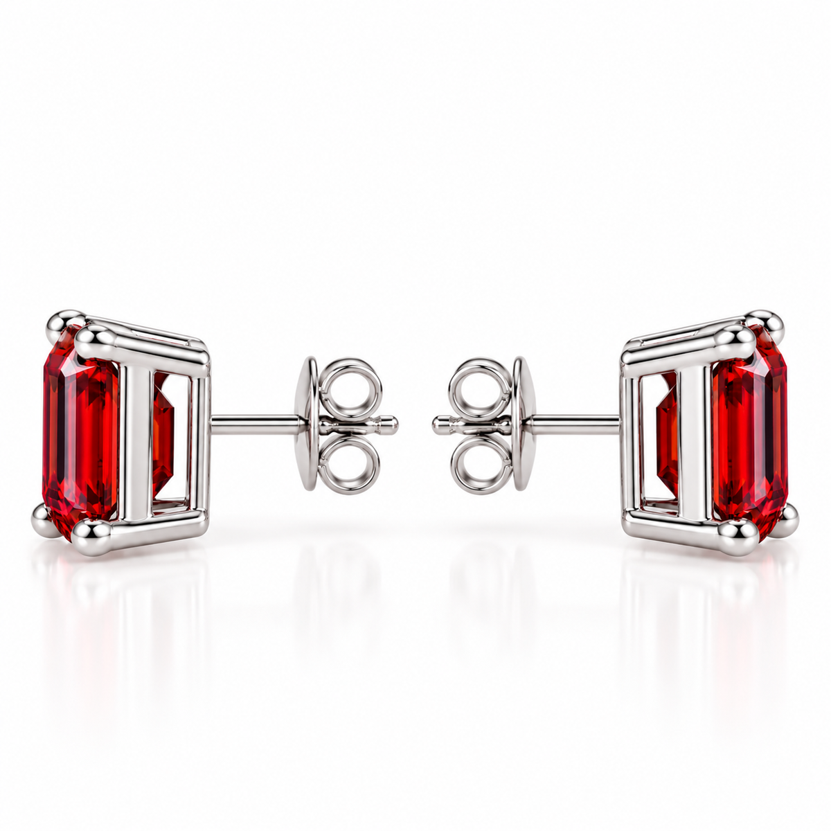 Side profile of natural 6x8mm red garnet emerald cut stud earrings showing rectangular gemstone depth, polished sterling silver open-gallery settings, four rounded corner prongs, centrally positioned posts, and butterfly backs.