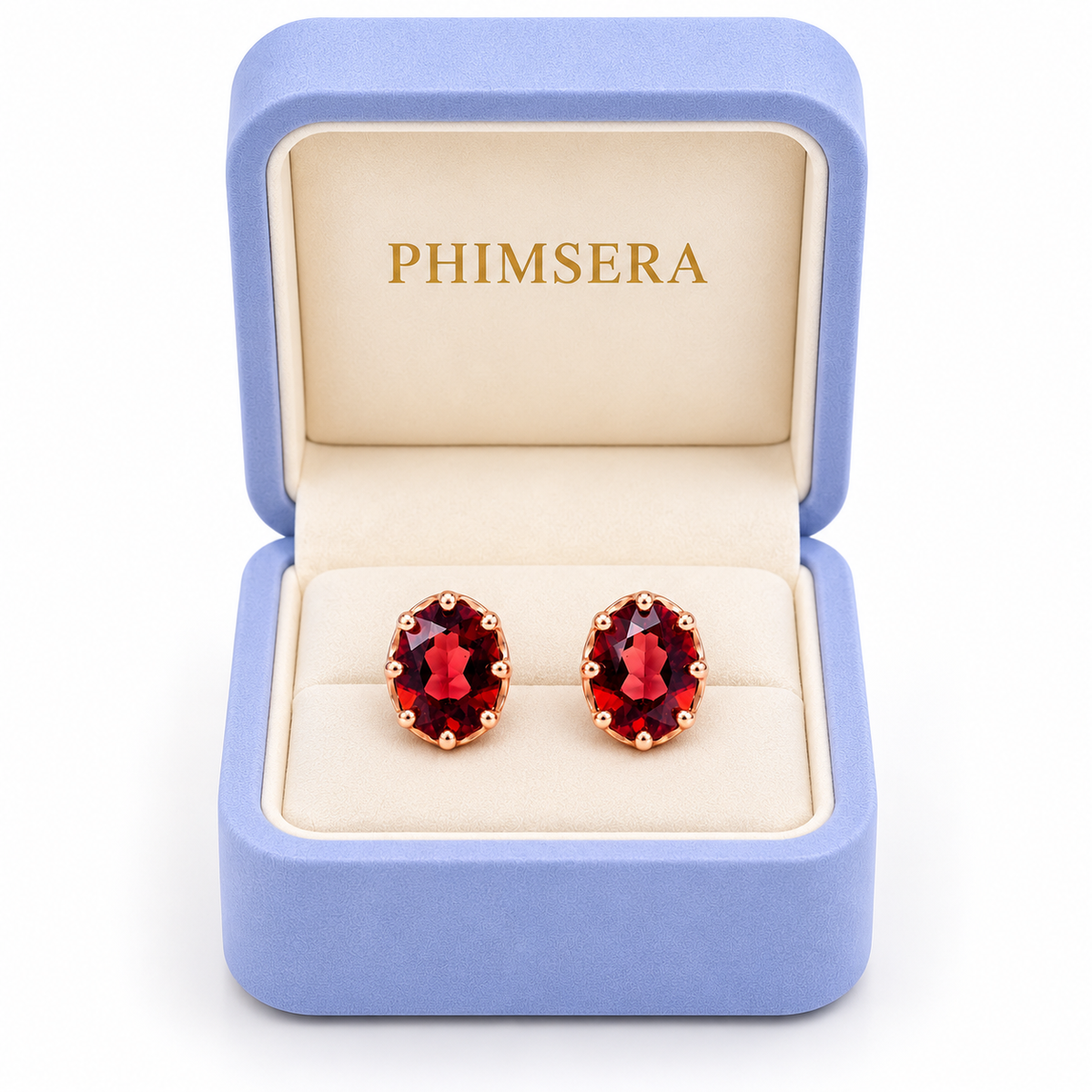 Natural 6x8mm red garnet oval stud earrings displayed inside an open periwinkle Phimsera jewelry gift box with an ivory interior, gold Phimsera logo, and pure white background.