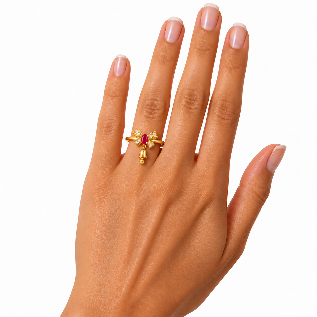 Front view of a delicate gold-plated sterling silver ruby bow ring worn on a woman's ring finger, featuring a small 3x4mm oval natural ruby and miniature hanging Christmas bell on a white background.