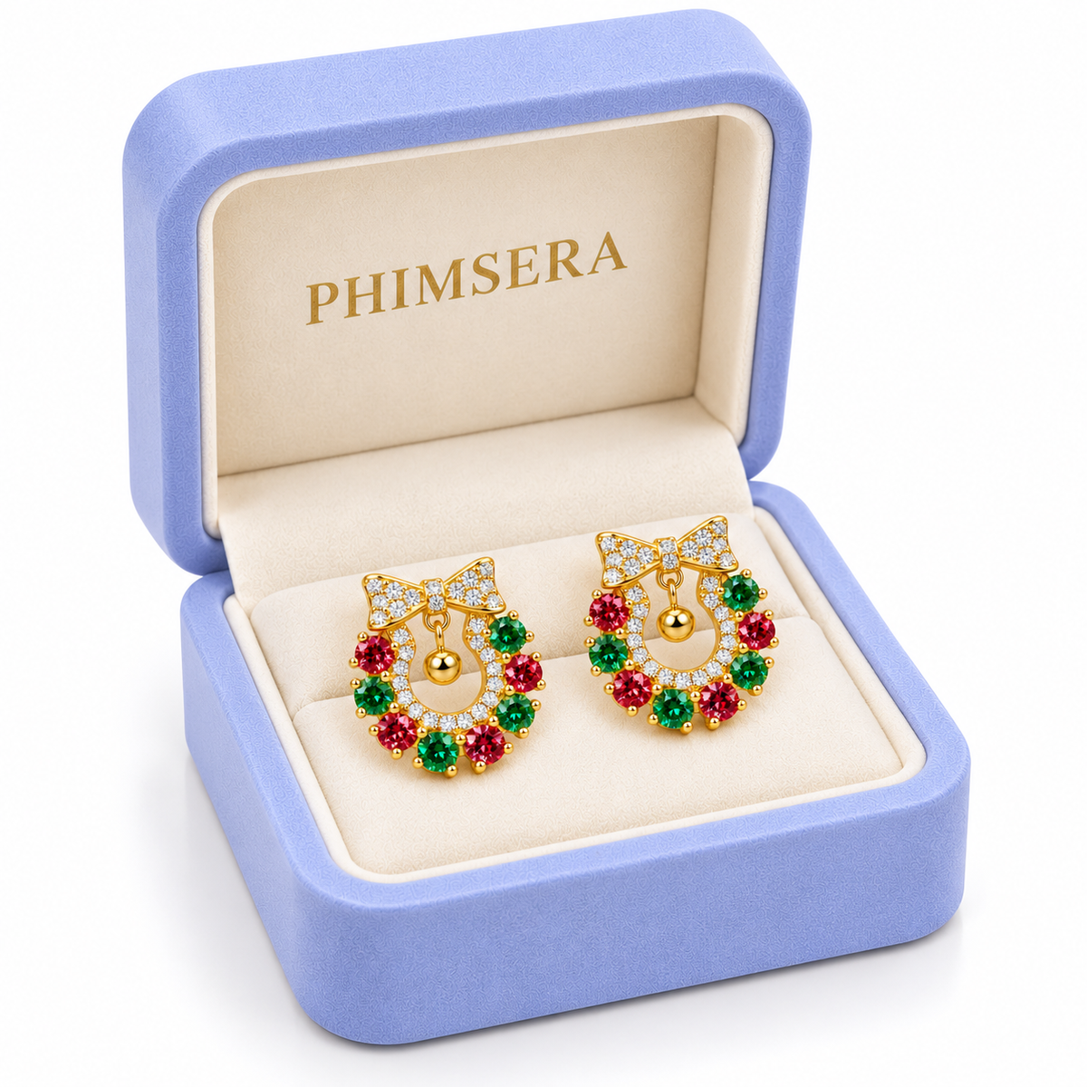 Three-quarter view of gold-plated Christmas wreath earrings with sparkling red and green moissanite gemstones presented inside an elegant periwinkle Phimsera jewelry box.