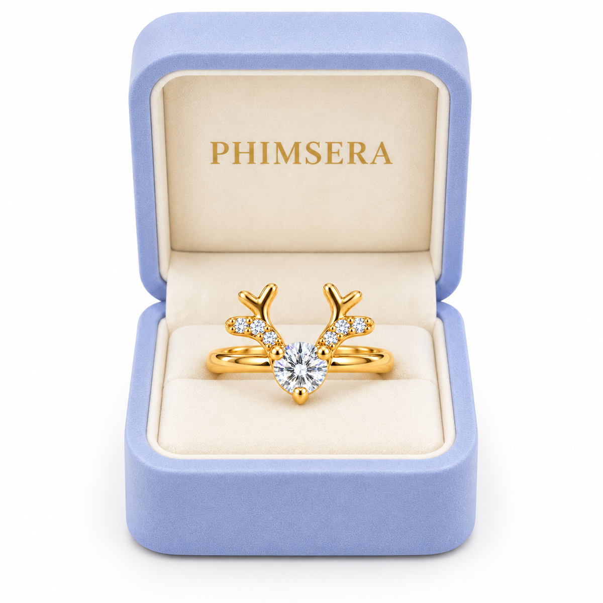 Phimsera white moissanite Christmas reindeer antler ring displayed inside an open periwinkle jewelry gift box with ivory interior and gold Phimsera branding.