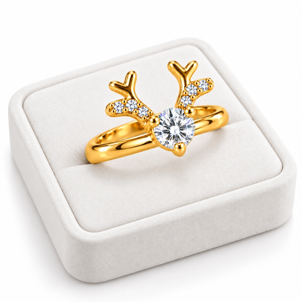 Angled white velvet jewelry tray displaying a gold-plated sterling silver reindeer ring with brilliant white moissanite and sparkling cubic zirconia antlers.