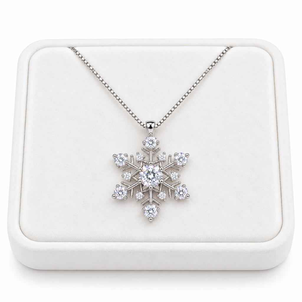 White moissanite snowflake pendant necklace displayed on a premium white velvet jewelry tray against a pure white background, featuring a delicate sterling silver chain and sparkling white gemstones.