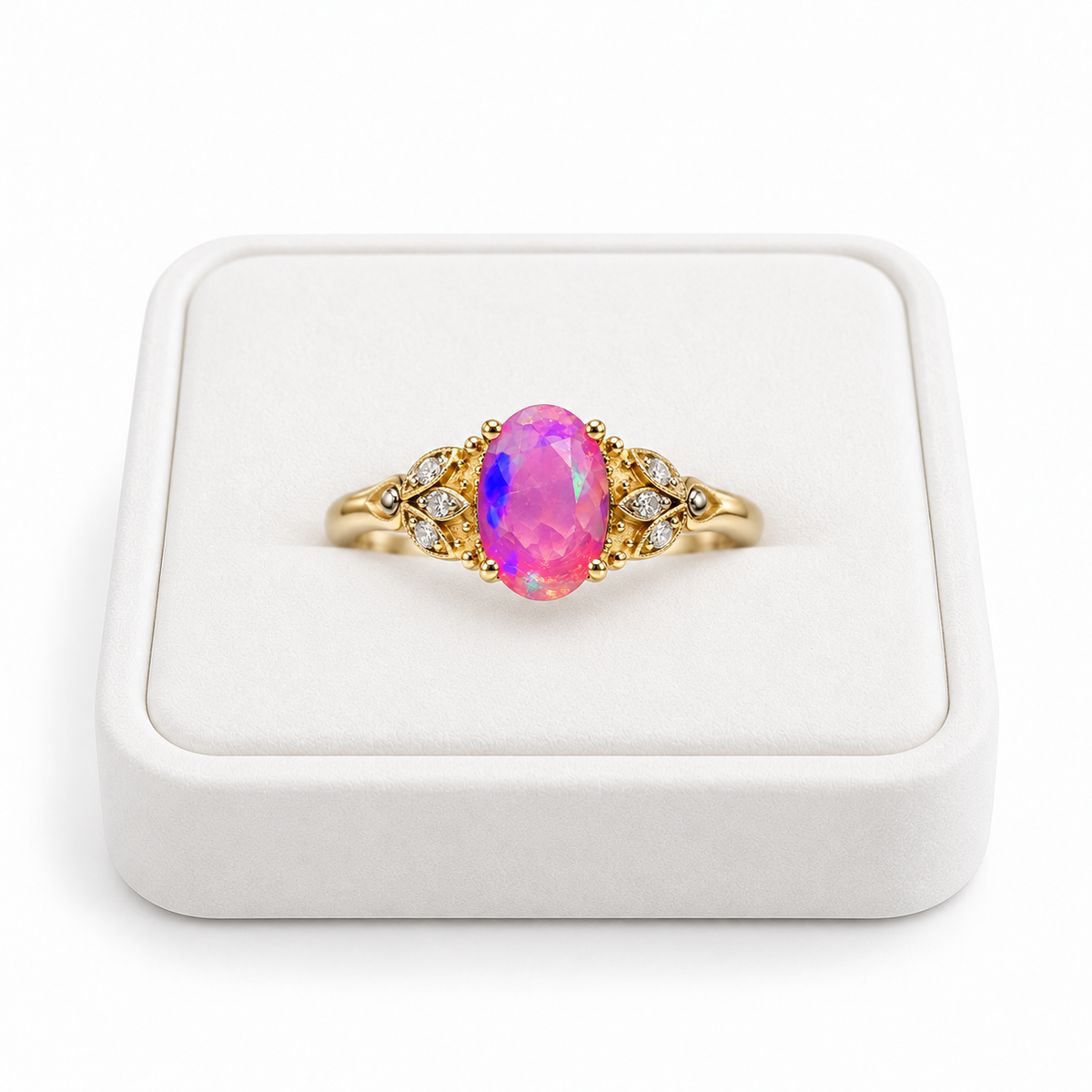 Gold Plated pink fire opal ring with a 5x8mm oval gemstone displayed on a white velvet jewelry tray against a clean white background.